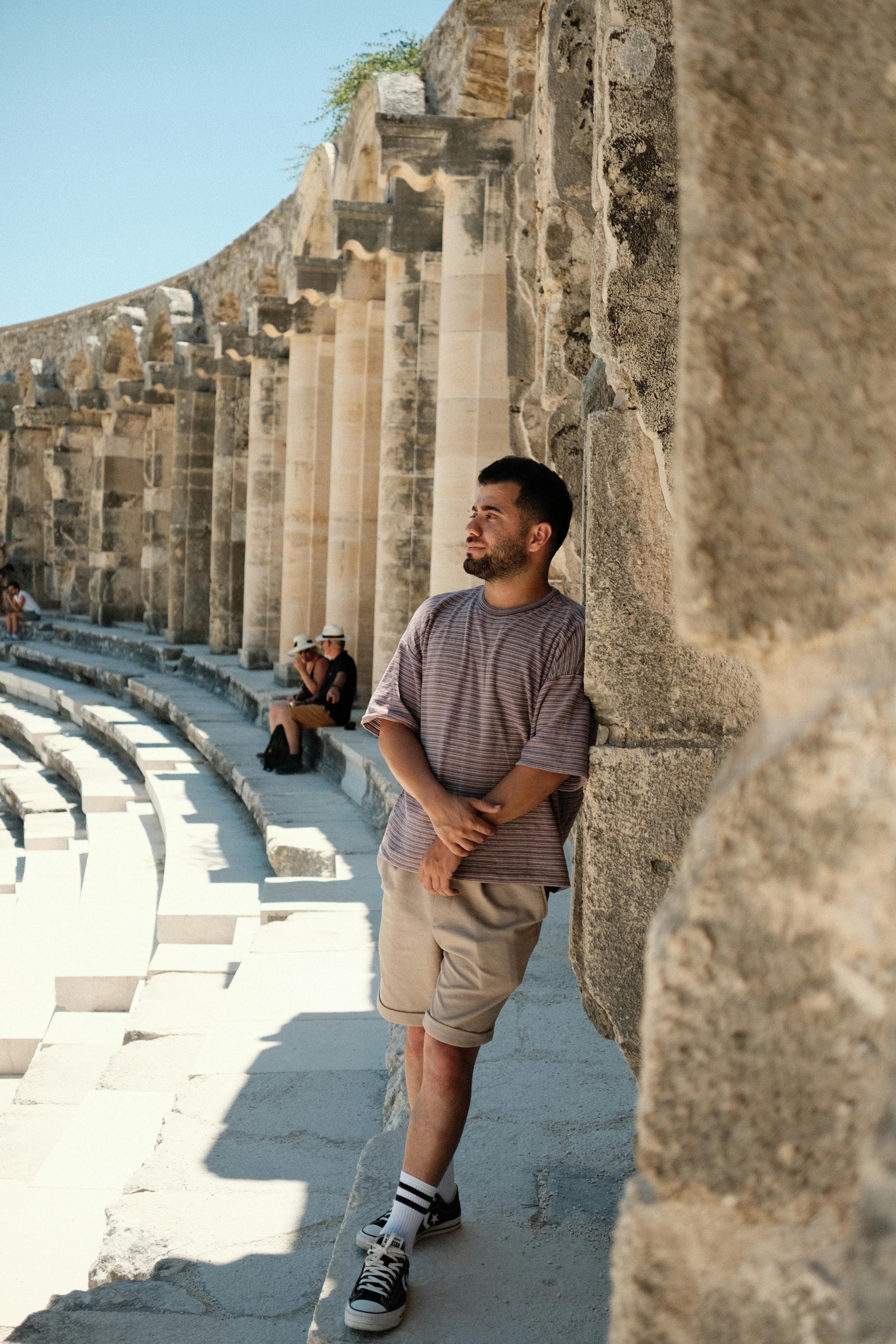 a man standing in an ancient roman theatre