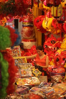 Colorful display of traditional lanterns and toys at a vibrant street market.