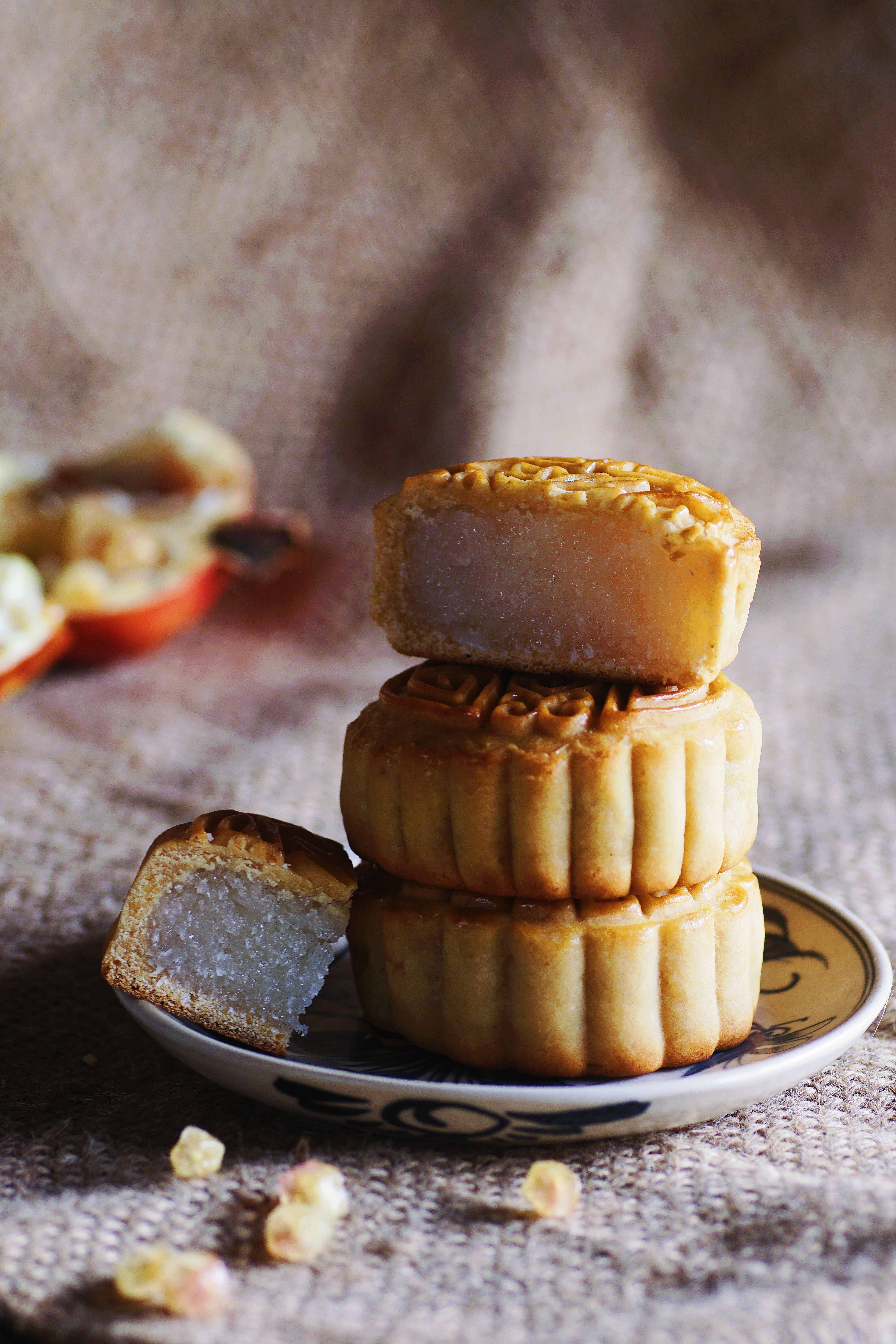 Close-up of delicious traditional mooncakes stacked on a decorative plate, perfect for Mid-Autumn Festival.