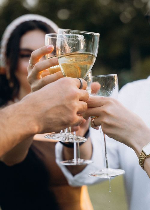 Free Group of friends toasting with champagne glasses during an outdoor celebration. Stock Photo