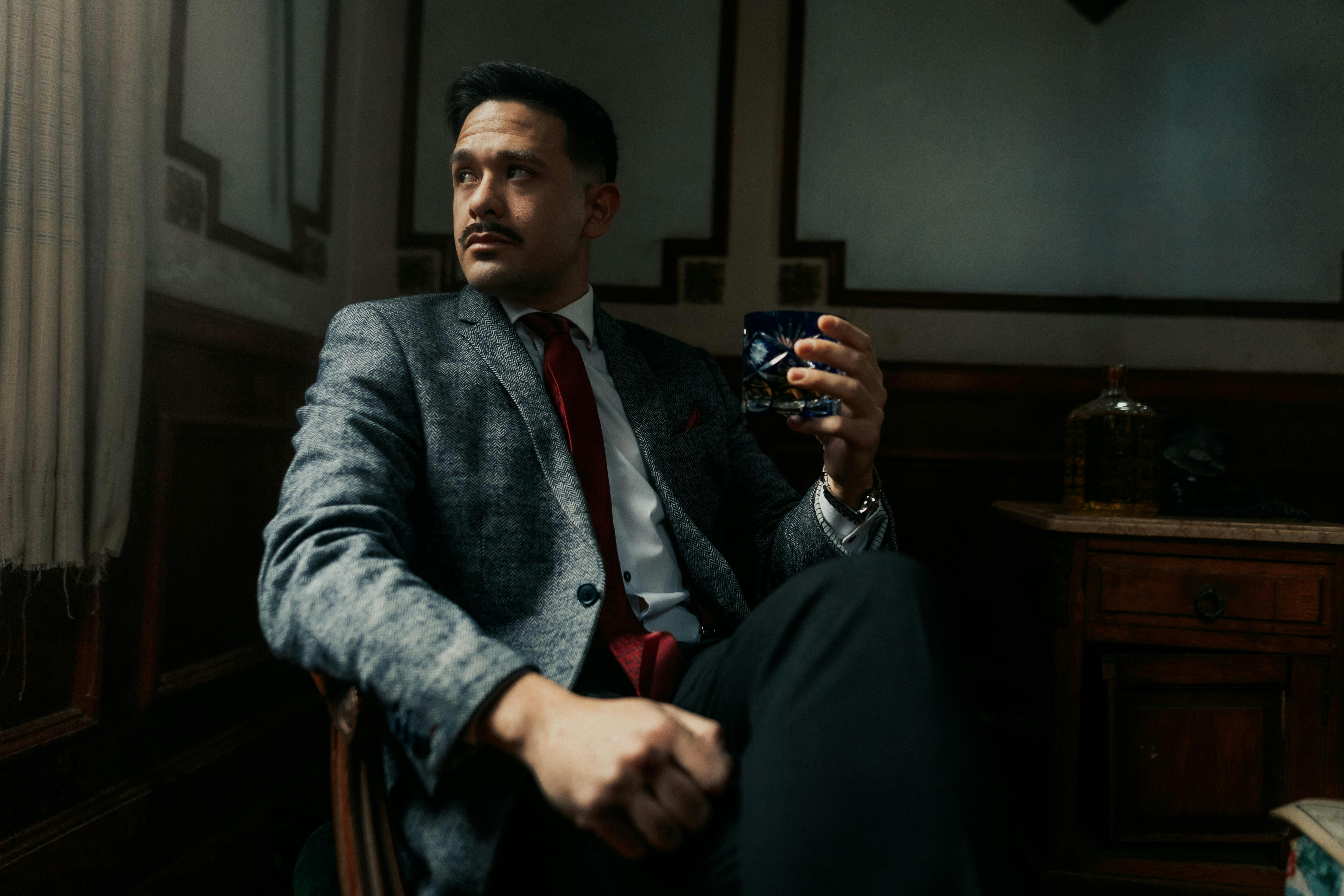 Portrait of a sophisticated man in a vintage styled room in Buenos Aires, Argentina.