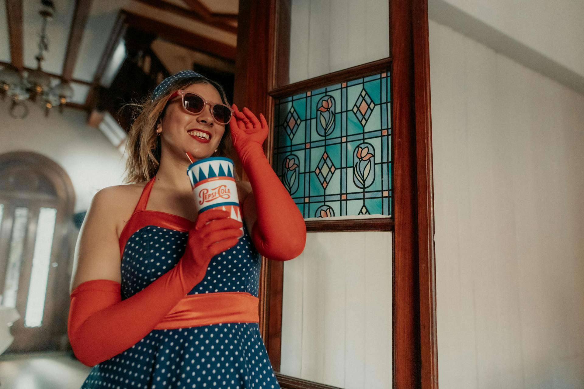 A fashionable woman in retro style enjoying Pepsi in a Buenos Aires interior.