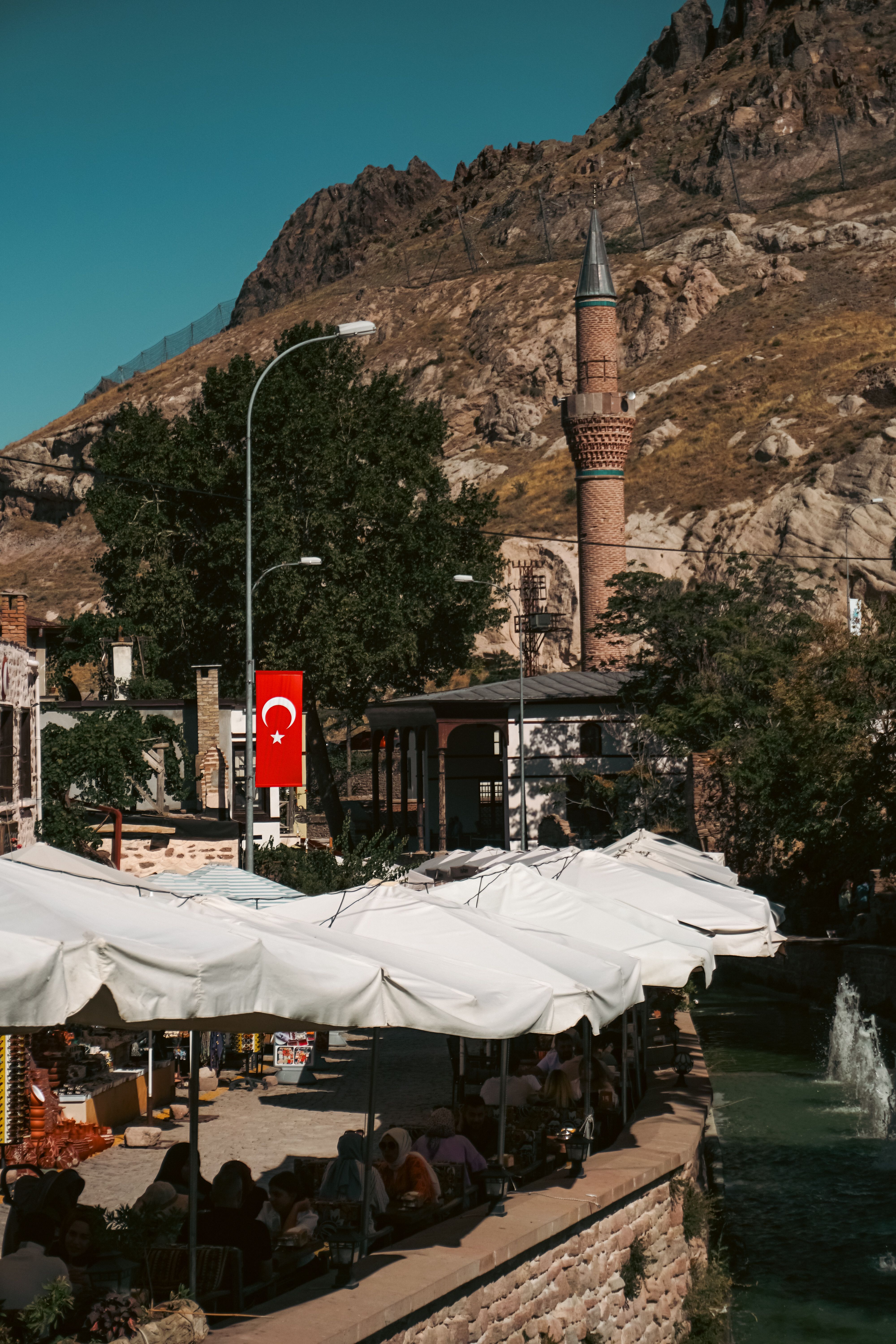 Scenic view of a historic mosque and bustling market in Sille Subaşı, Konya, Türkiye.