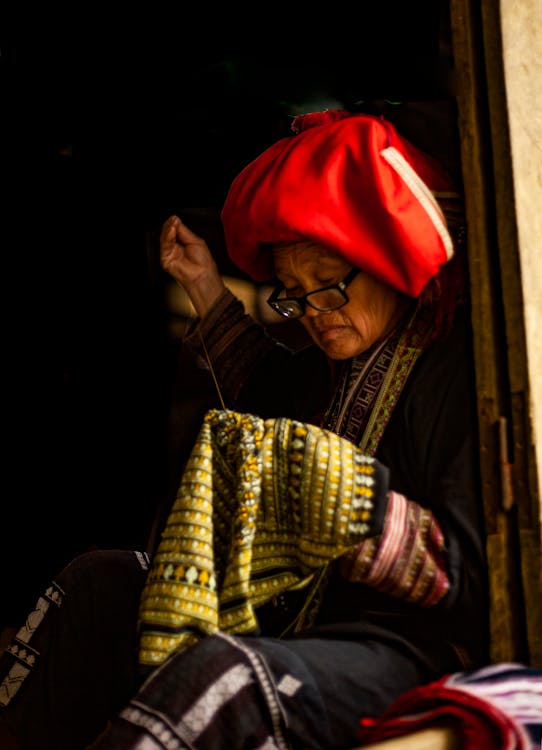 Photo of a Woman Sewing Clothes