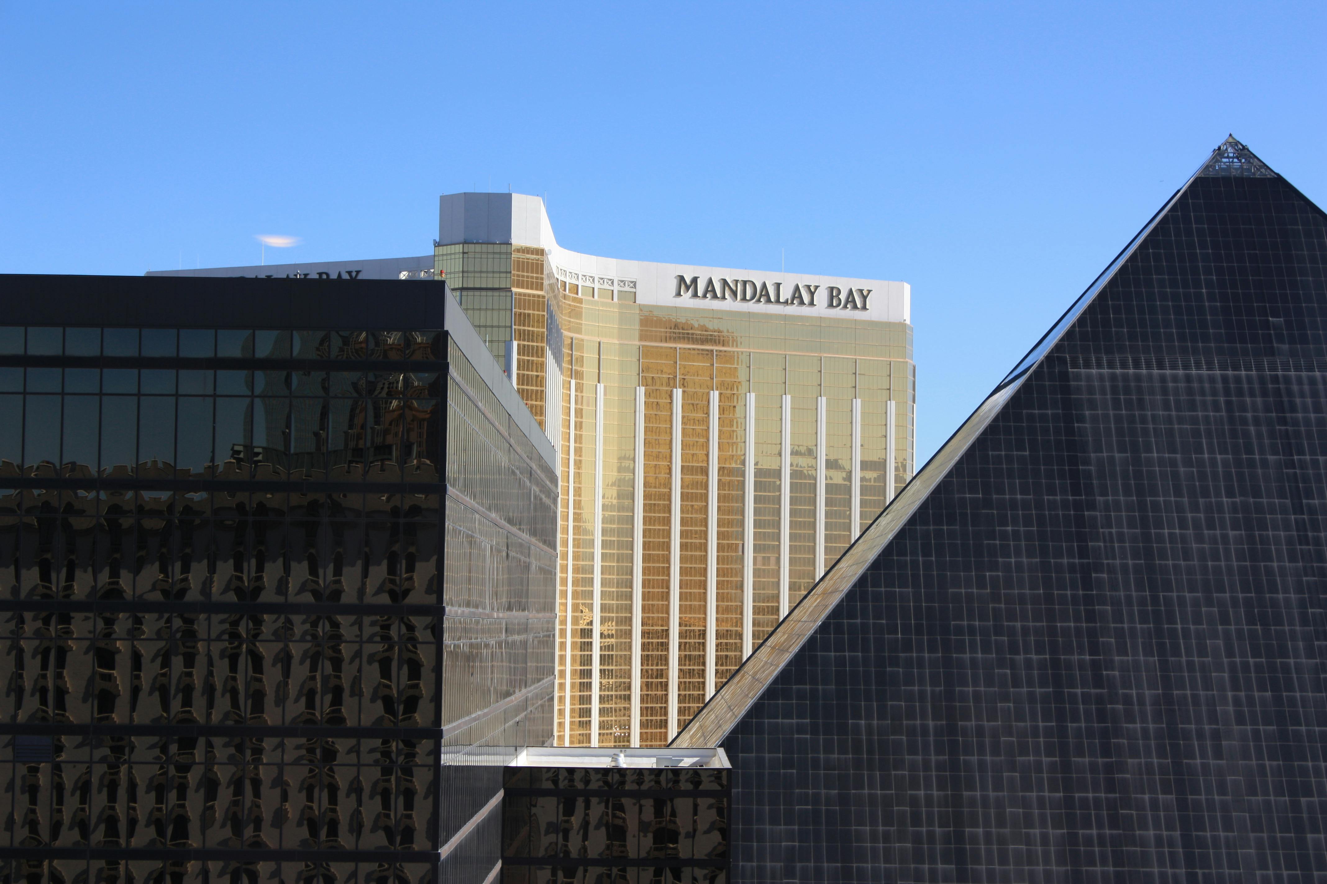 Las Vegas architectural skyline featuring Mandalay Bay and Luxor Pyramid under clear sky.