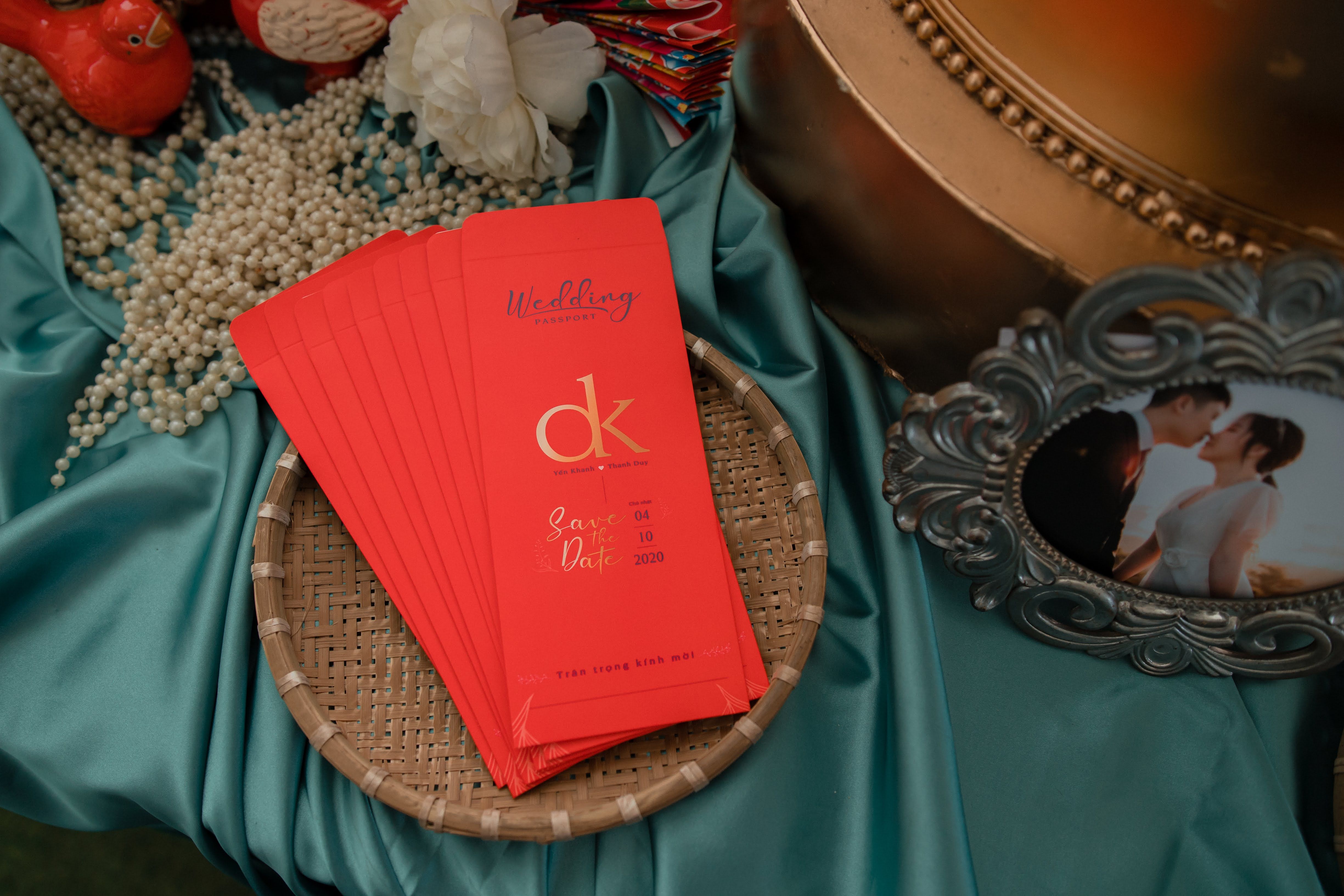 A beautifully arranged wedding invitation with pearls and a romantic photo.