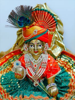 Colorful and detailed statue of Lord Krishna with traditional attire and decorations.