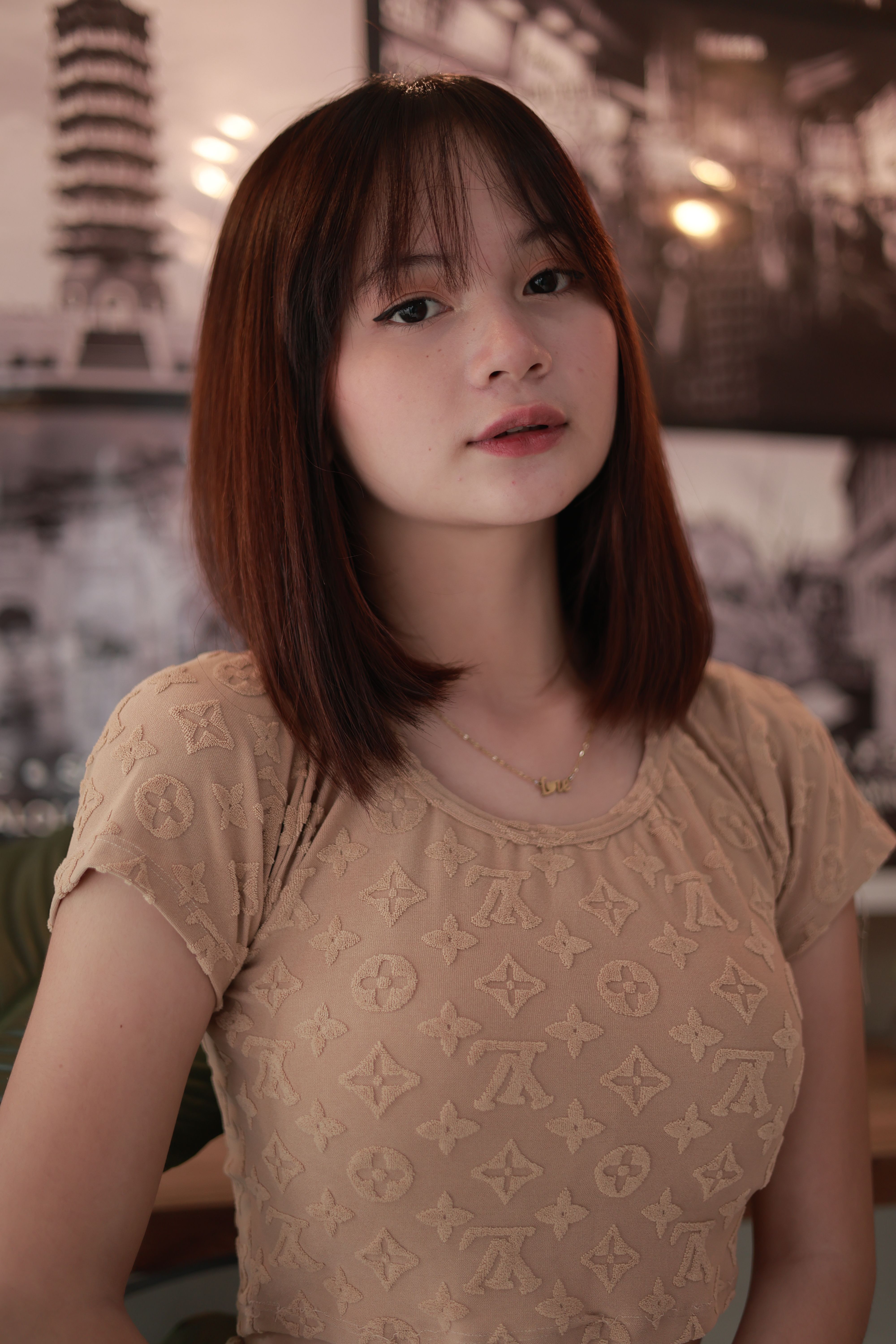 Beautiful portrait of a young woman with brunette hair, captured in a stylish indoor setting.