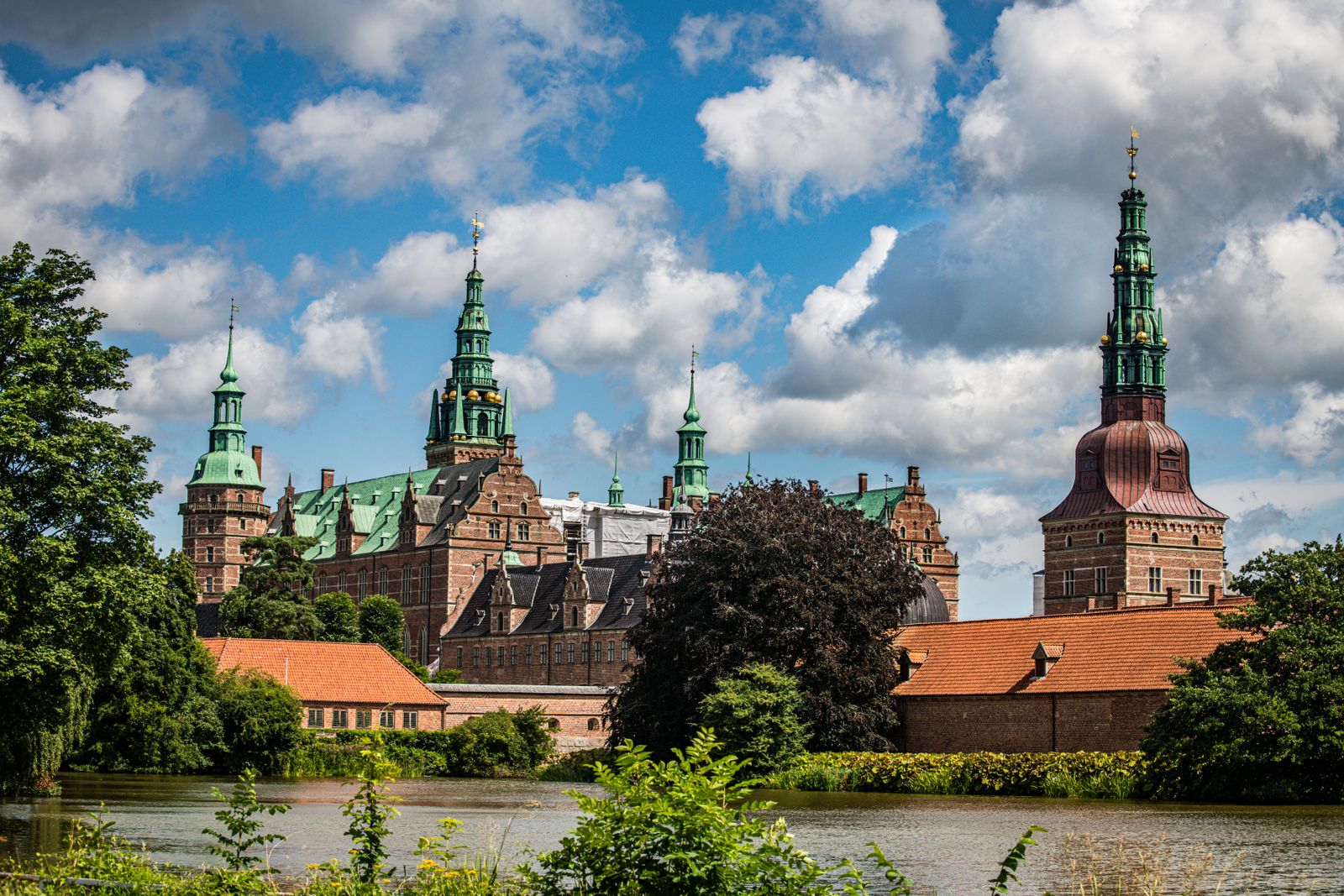 Frederiksborg Castle towers and spires rising above lake and gardens in North Zealand