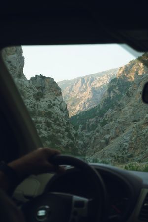 Driving through a rocky canyon at sunset, photo by Beyza Oruk on Pexels