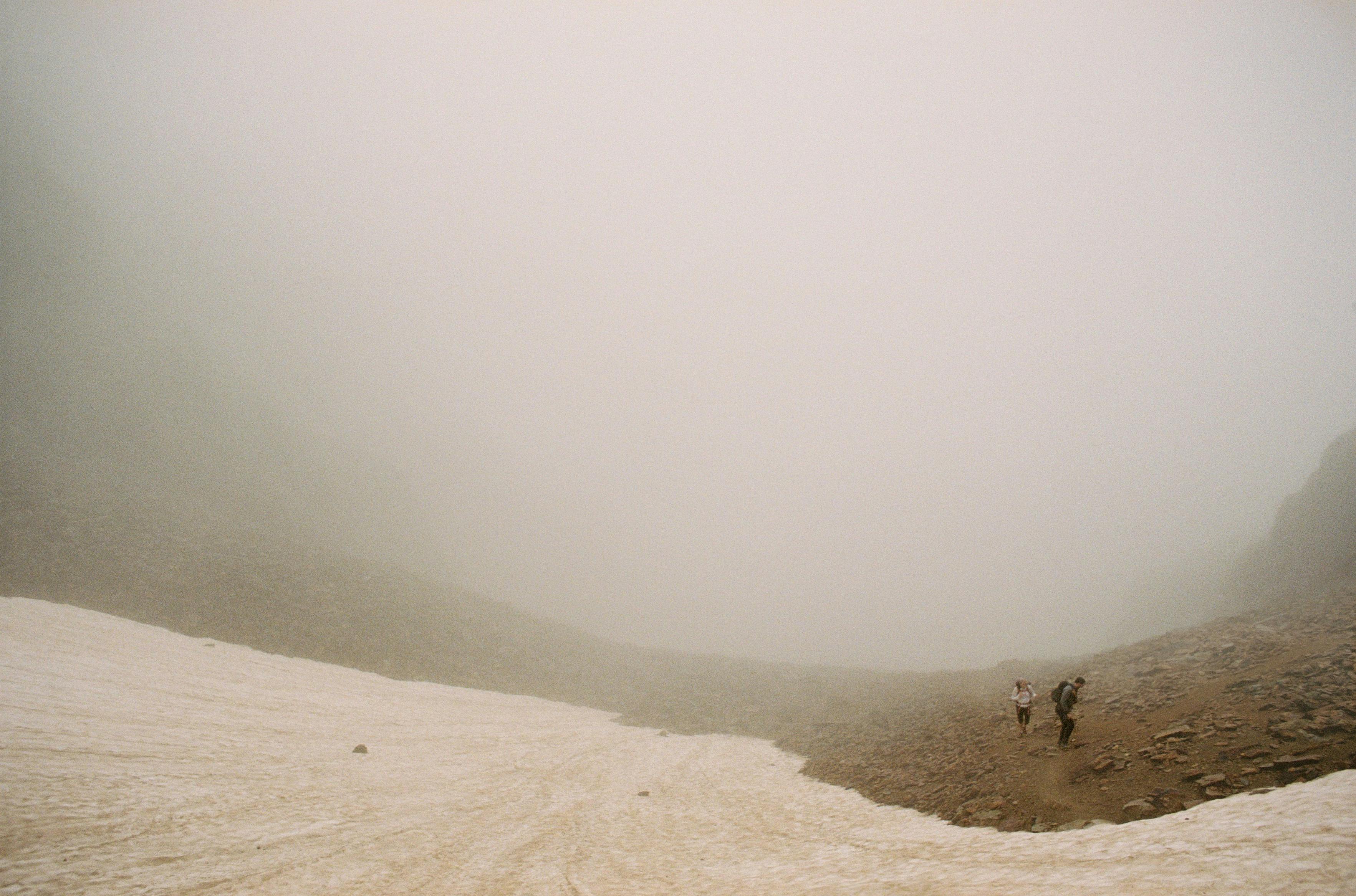 a person walking on a snowy mountain