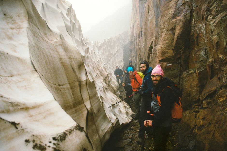 A group of hikers explore a dramatic ice and rock landscape, showcasing the thrill of outdoor adventures.