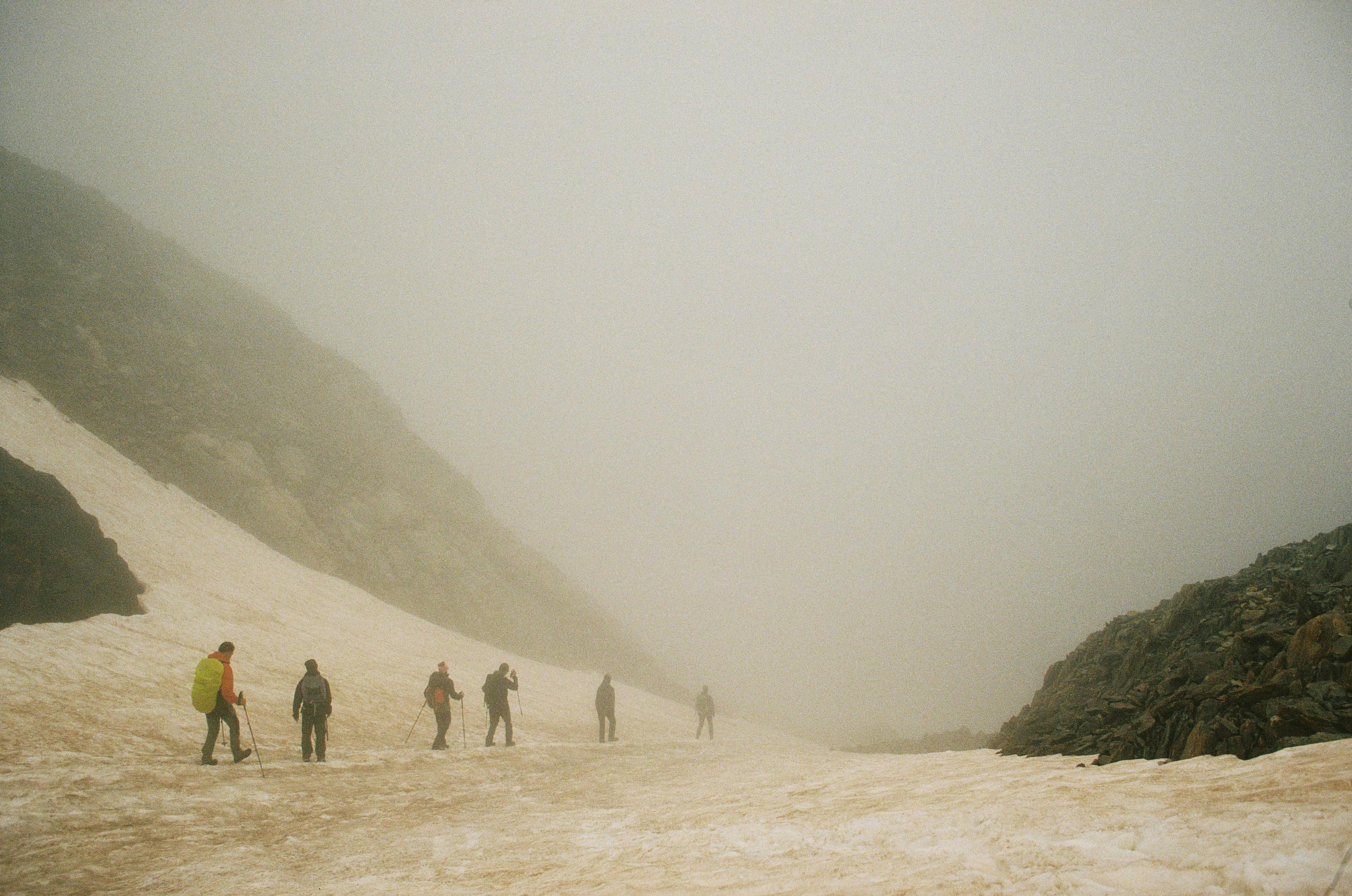 Adventurers navigate a foggy mountain landscape in Spain, capturing a serene winter trek.