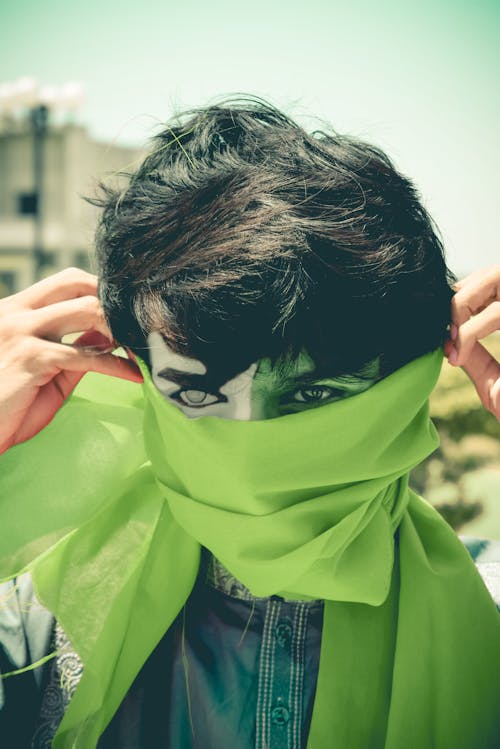 Person Covering Face With Green Cloth