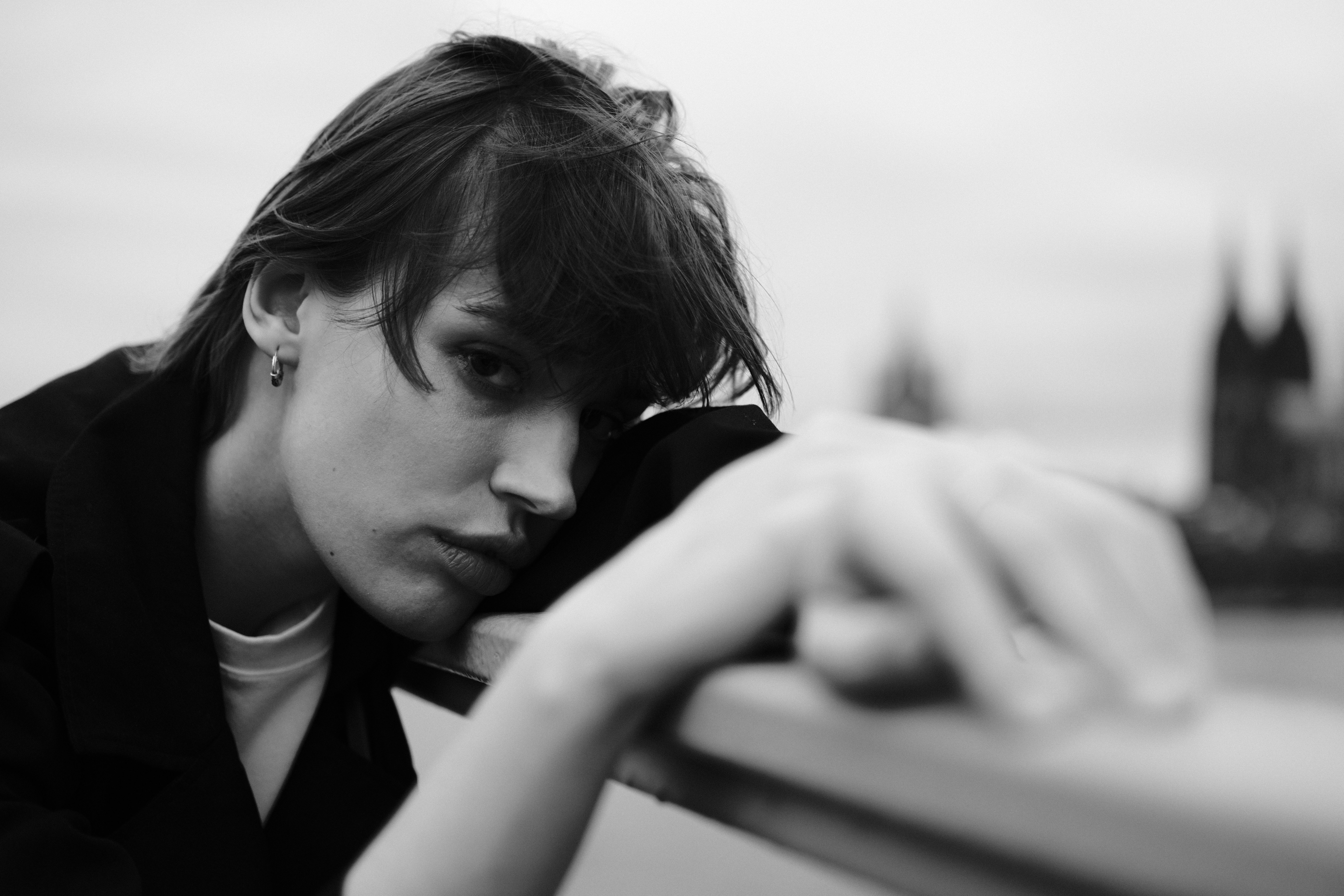 A woman leaning against a railing with her head down · Free Stock Photo