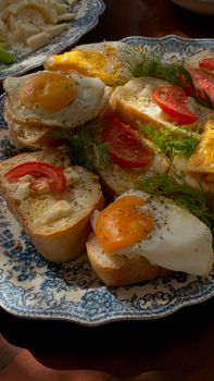 Savor a delightful brunch with these open-faced egg and tomato sandwiches garnished with fresh dill.