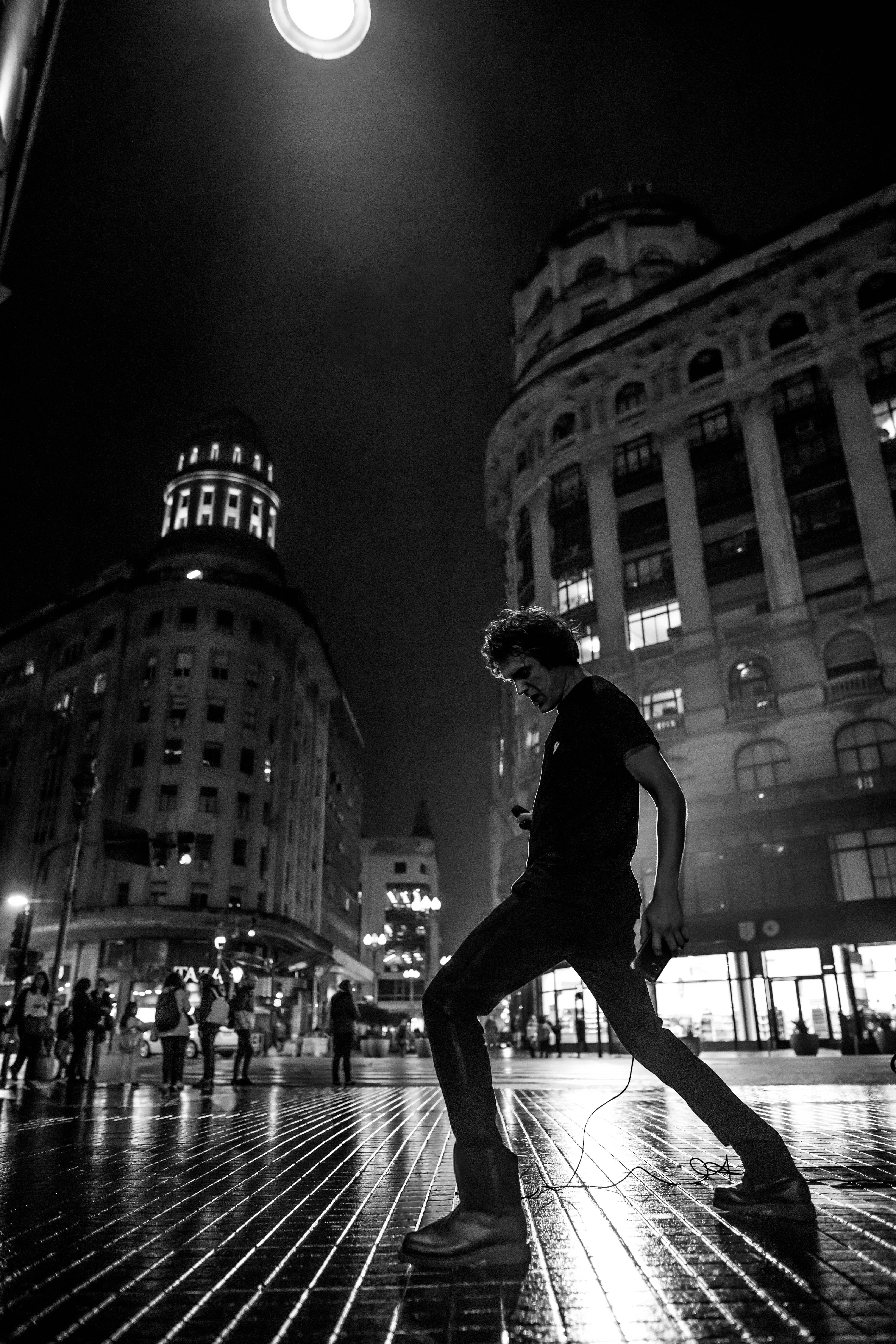 Silhouette of a man at night in front of iconic Buenos Aires architecture.