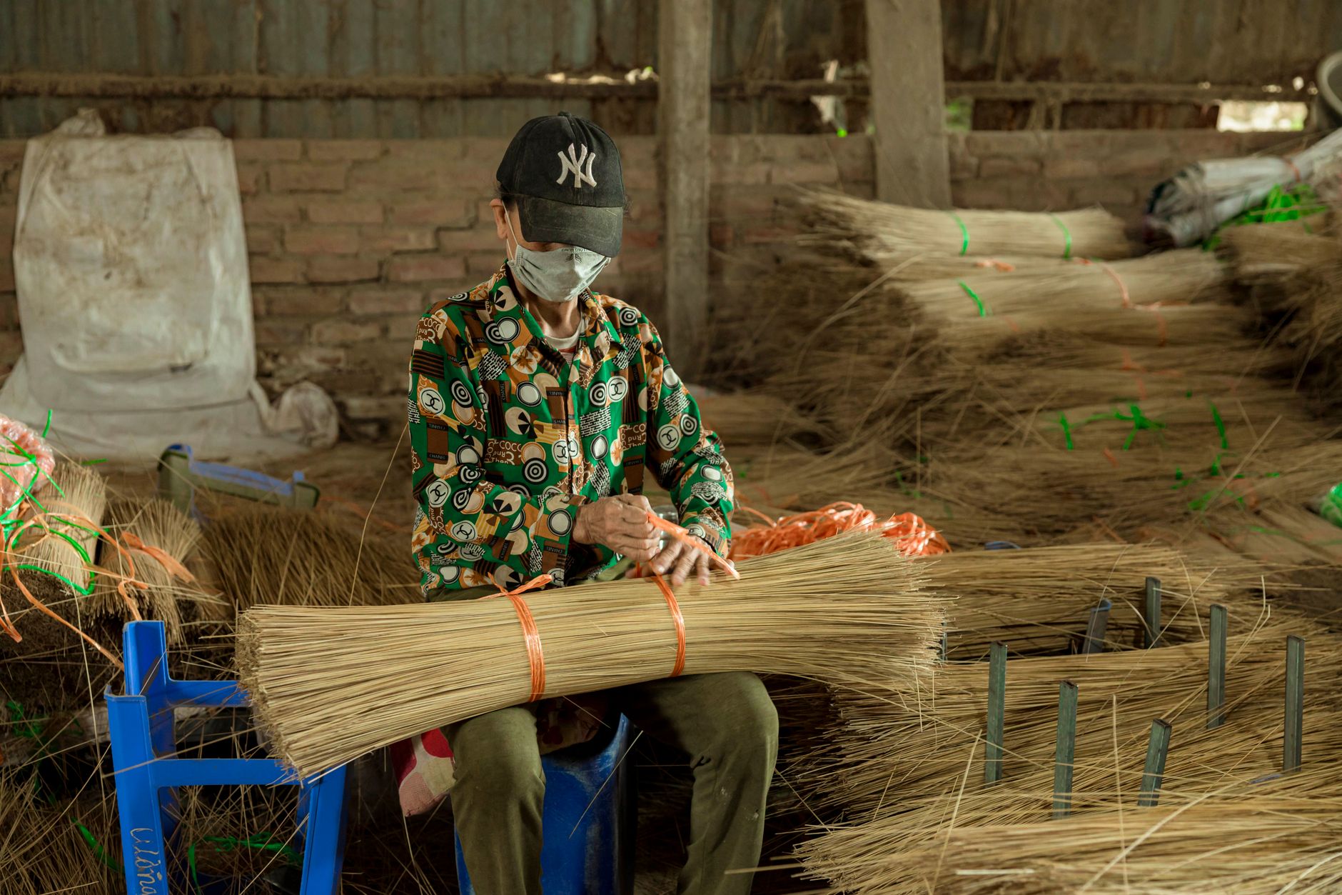 Men cutting straw materials