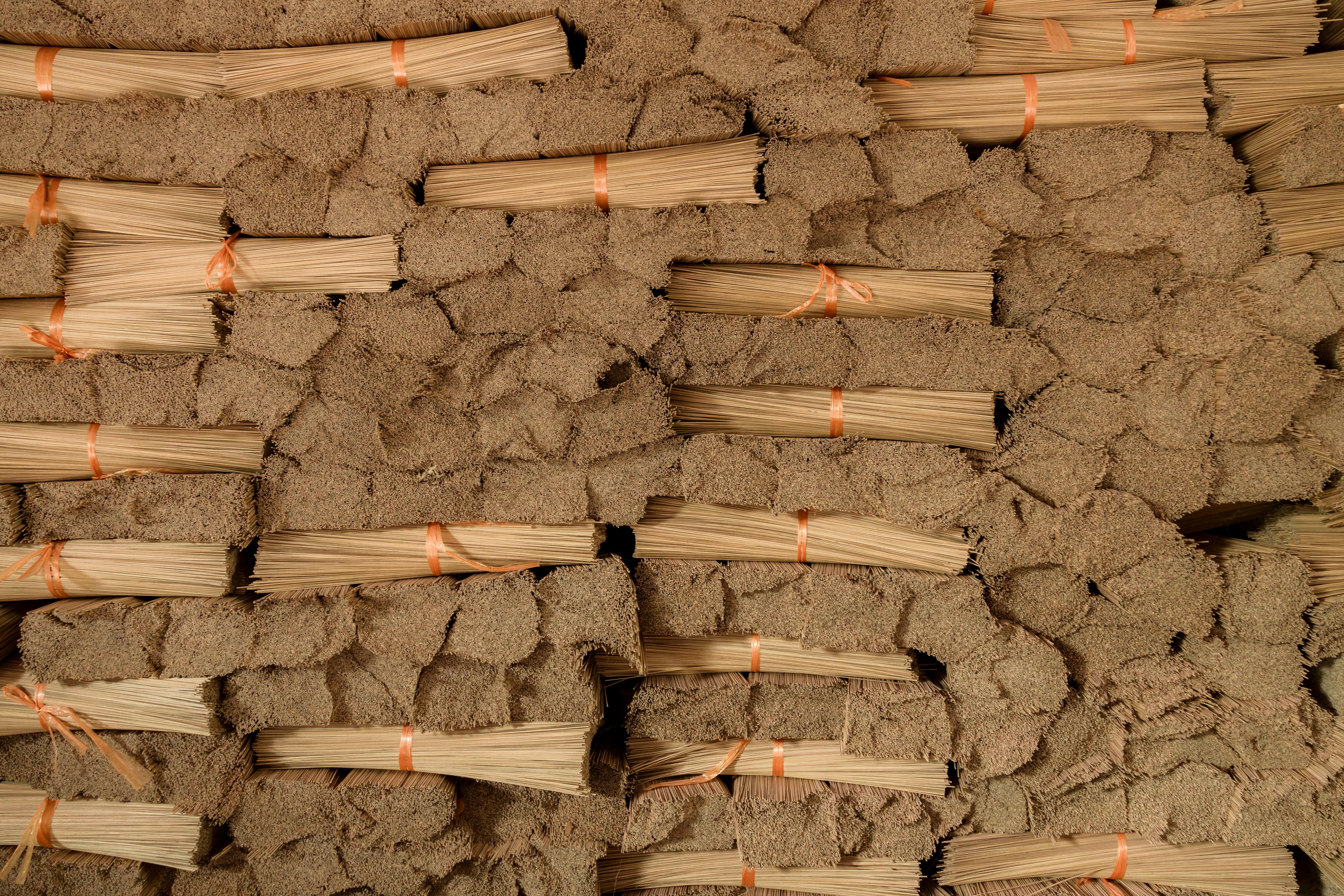 a pile of wood with orange strings tied to it