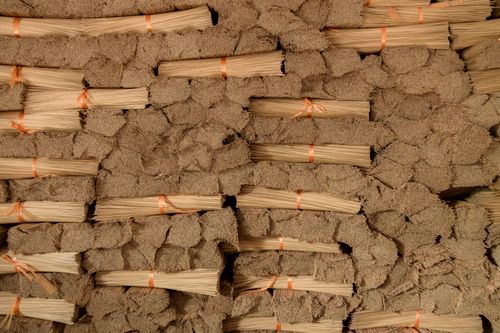 Free Stacks of bamboo broom heads tied with strings, ready for distribution in the warehouse. Stock Photo