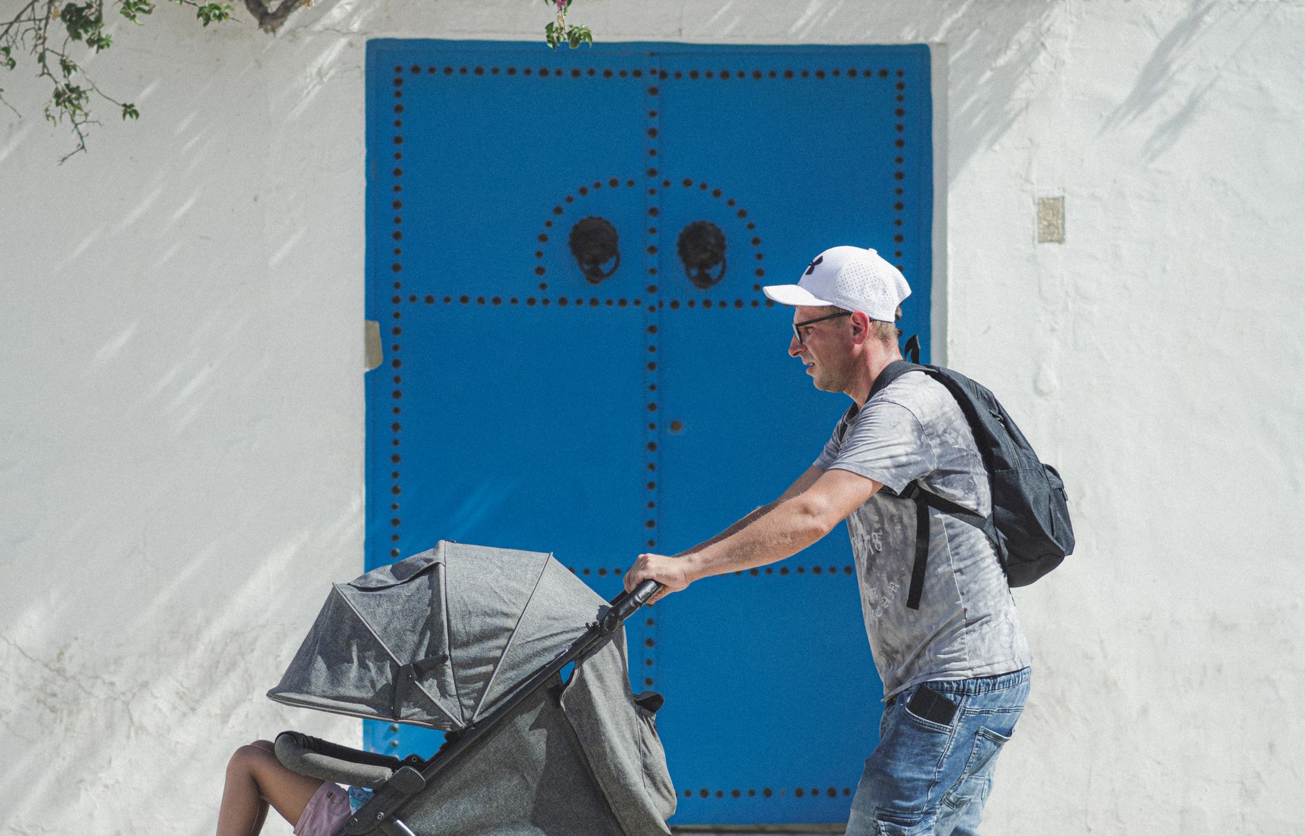 Father pushing stroller along riverside in Germany