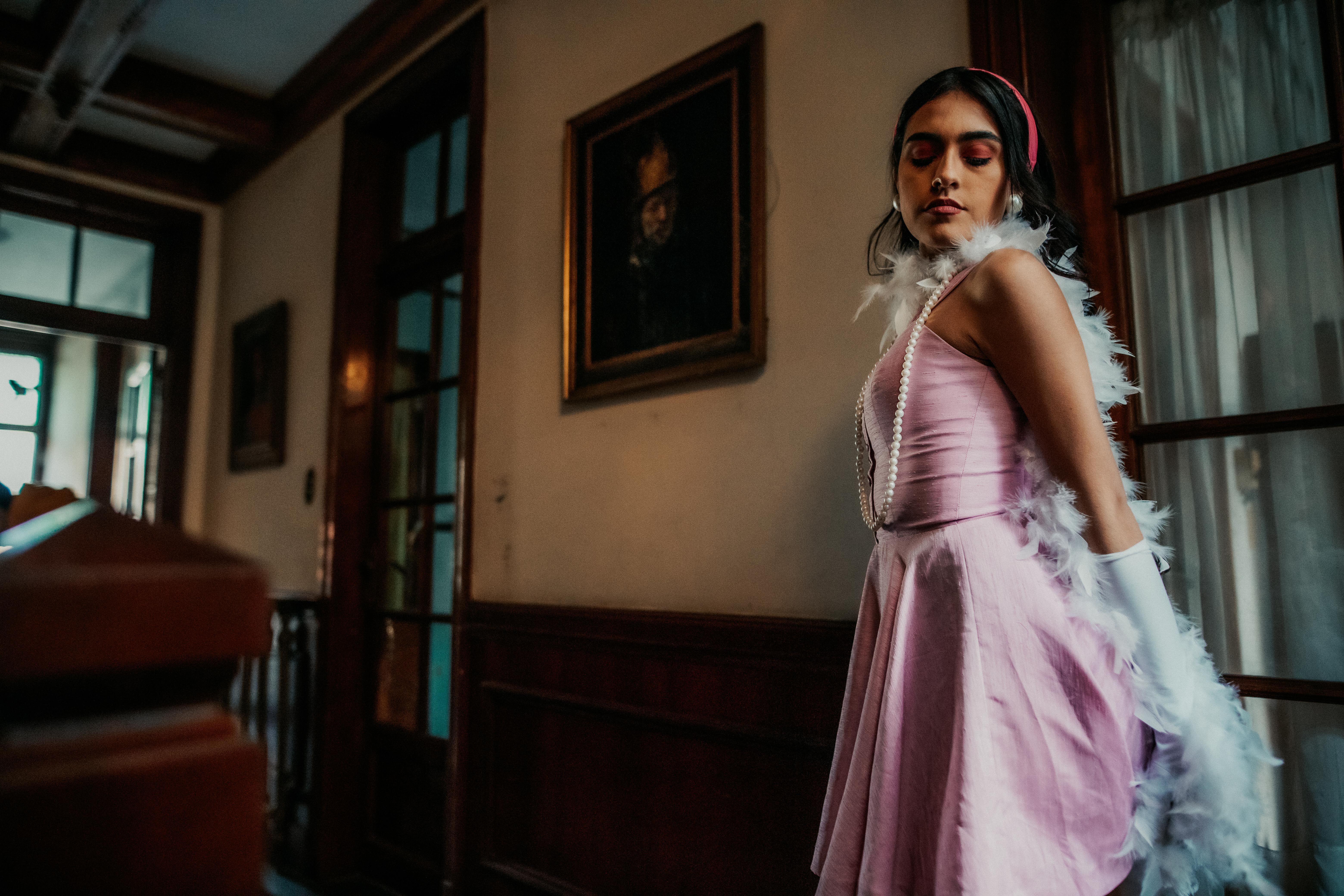 Elegant Young Woman in Vintage Pink Dress Indoors · Free Stock Photo