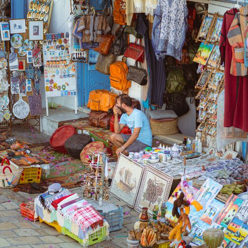 Free Colorful market stall in Carthage, Tunisia displaying handmade crafts and souvenirs. Stock Photo