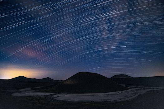 Capture the beauty of sweeping star trails over Turkey's unique terrain at night.