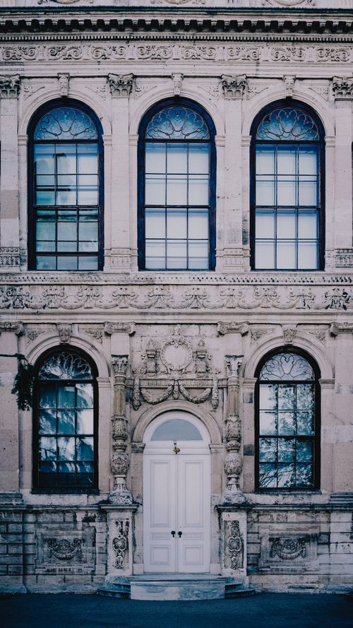 Free Detailed view of an ornate facade with large windows and a grand entrance in Istanbul, Turkey. Stock Photo