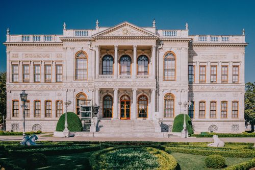 Free Front view of the historic Dolmabahçe Palace facade under a clear blue sky in Istanbul, Türkiye. Stock Photo
