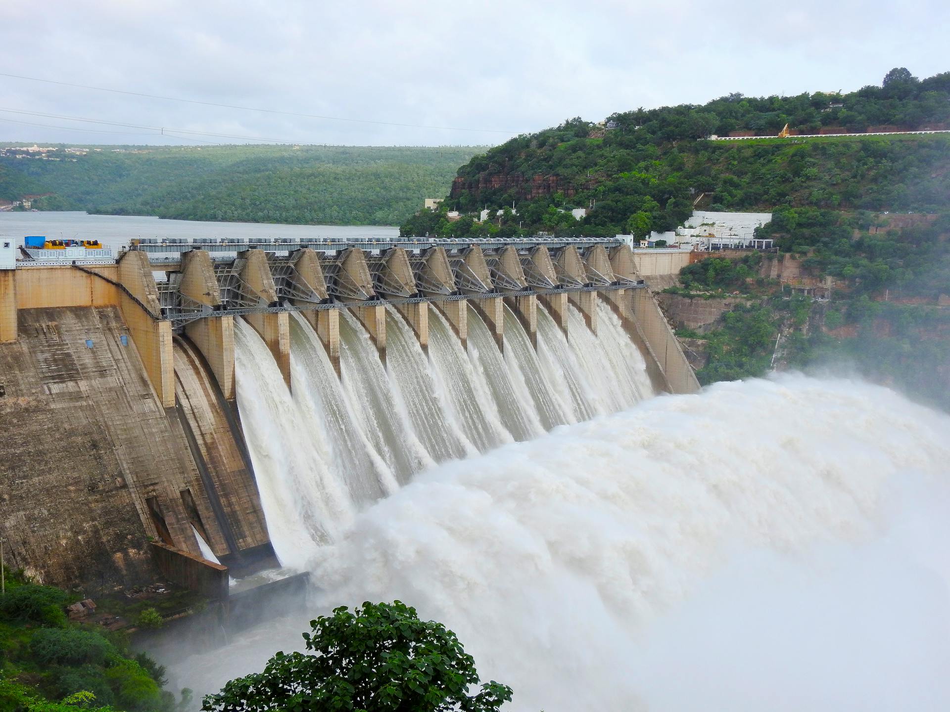 Majestic view of water flowing over Srisailam Dam in Andhra Pradesh, India.