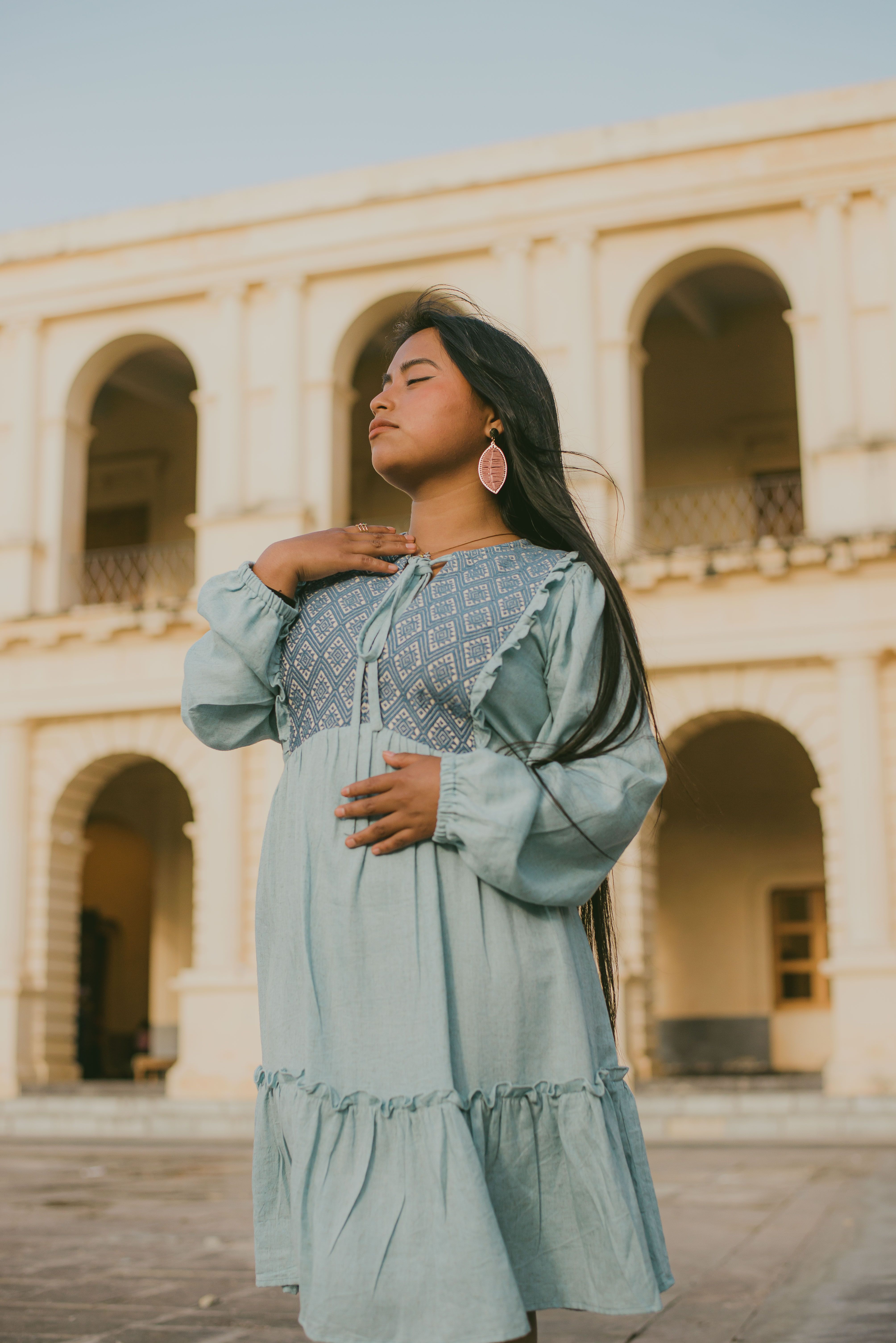 A woman in a blue dress stands outside · Free Stock Photo