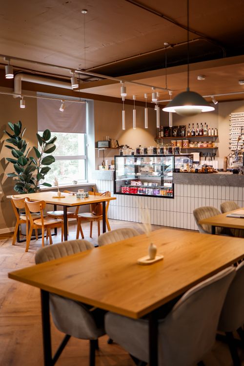 Free Elegant cafe interior with modern furniture and inviting atmosphere, ideal for relaxation or meeting. Stock Photo