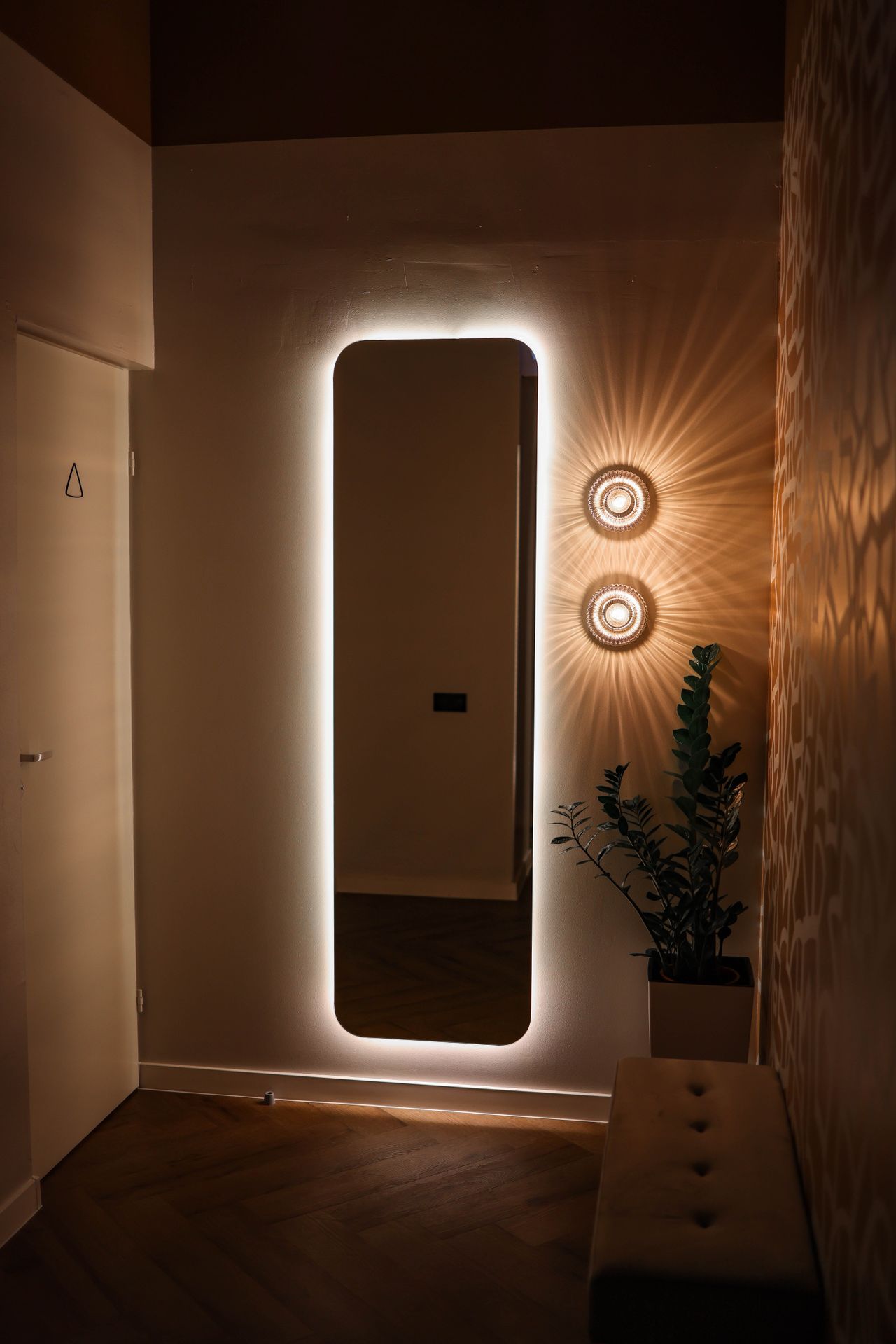 mirrors-expand-garage-space Backlit rectangular mirror mounted on a wall