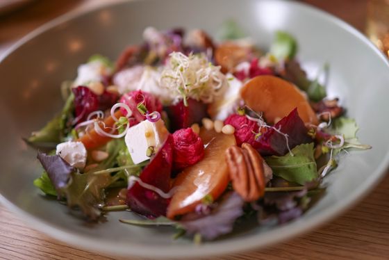 Mixed greens with roasted beets, caramelized peach wedges, feta, pecans, pine nuts and sprouts