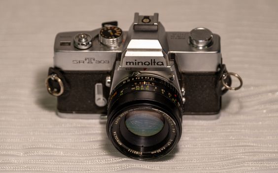 Close-up of a classic Minolta SR-T 303 analog camera showcasing vintage photography equipment.