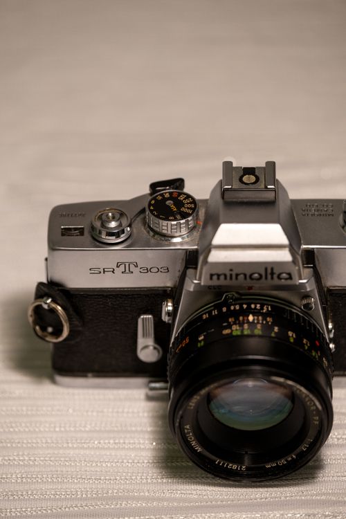 Free A close-up view of a classic Minolta SR-T 303 film camera showcasing its intricate details. Stock Photo