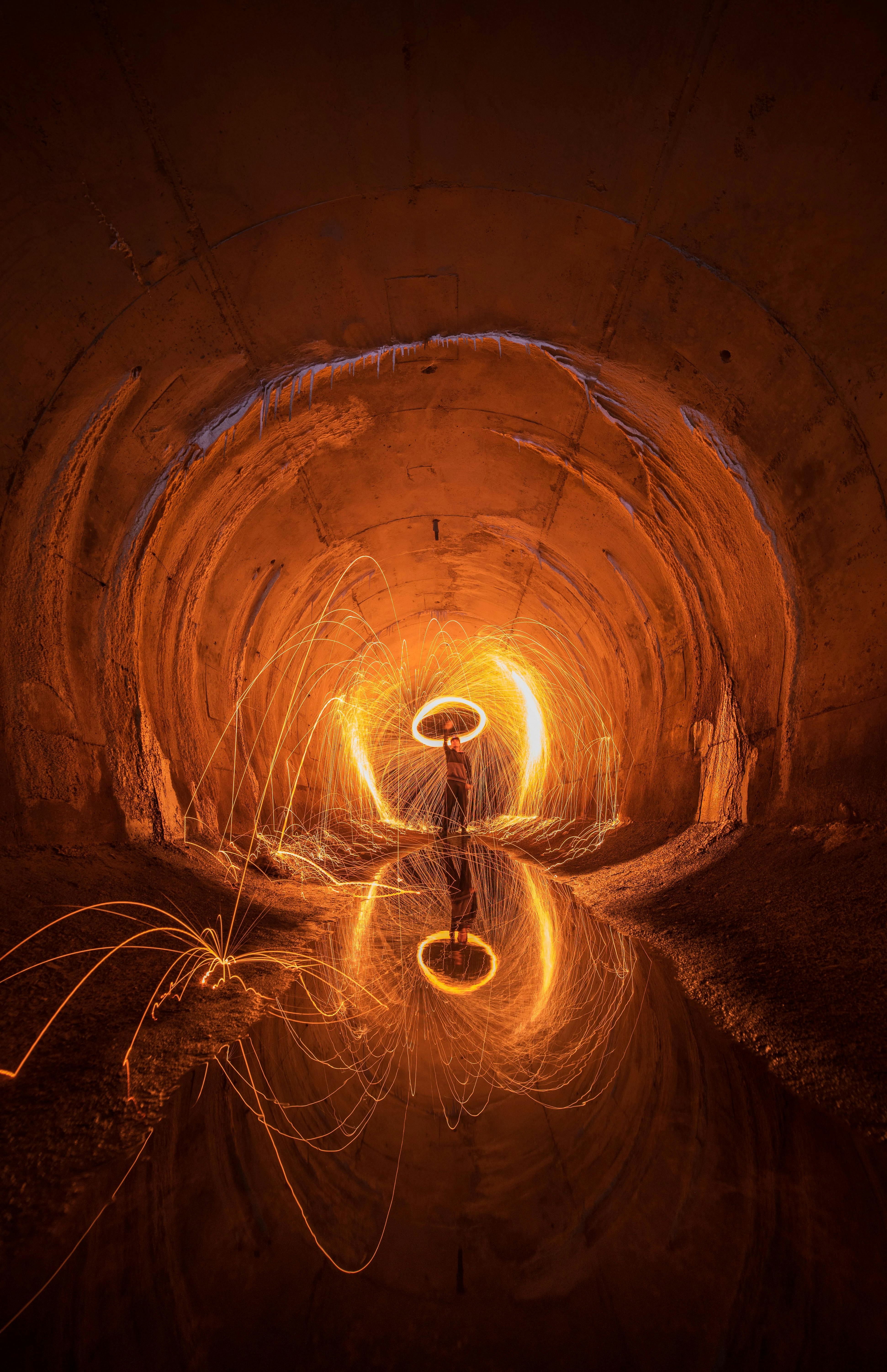 Dazzling fire spark performance in a tunnel creates a stunning visual effect.