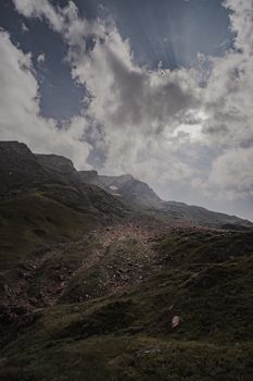 A dramatic view of a rocky mountain landscape under a cloudy sky, ideal for nature and travel themes.