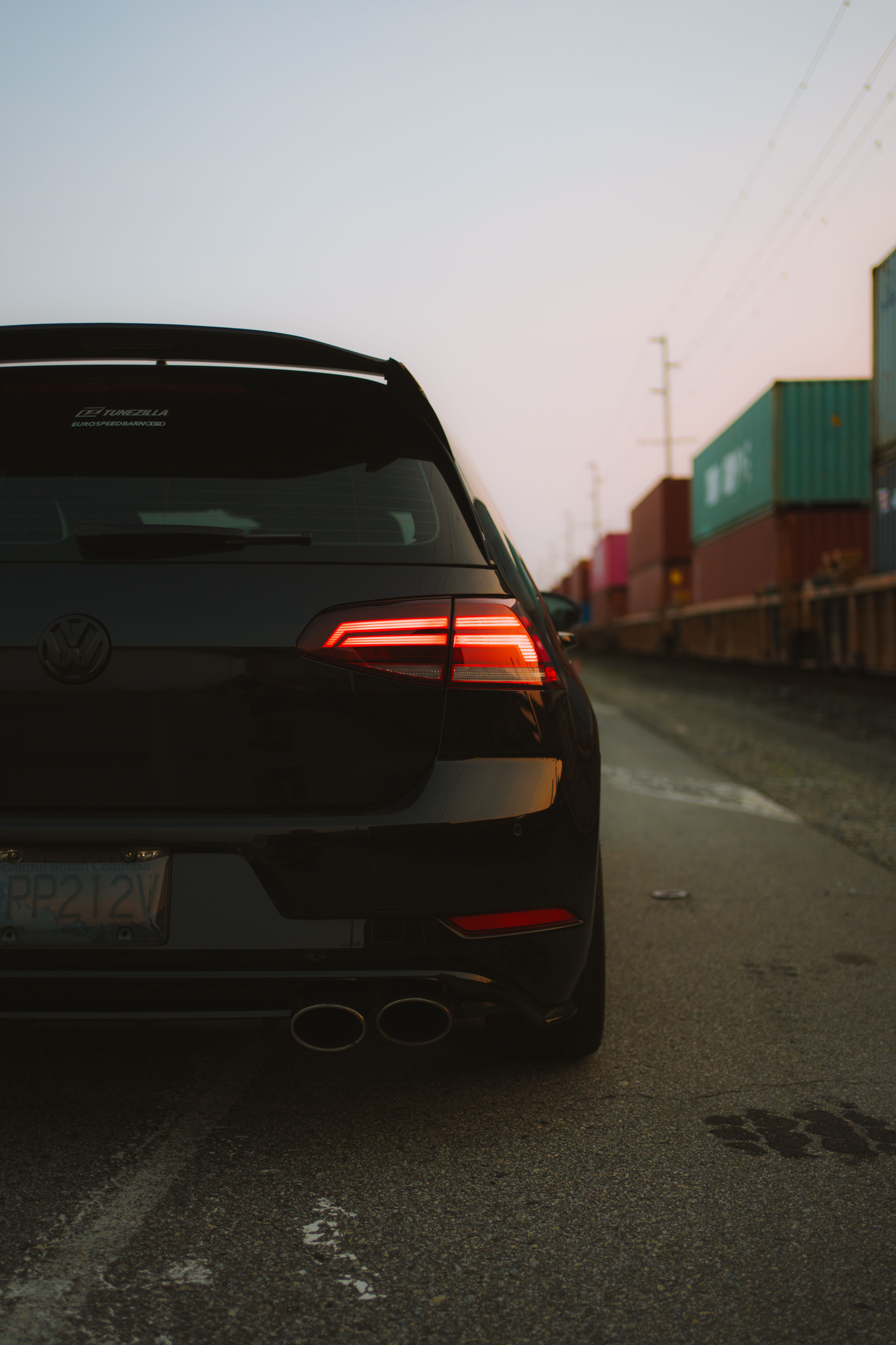 A black car with a rear end view on a road · Free Stock Photo