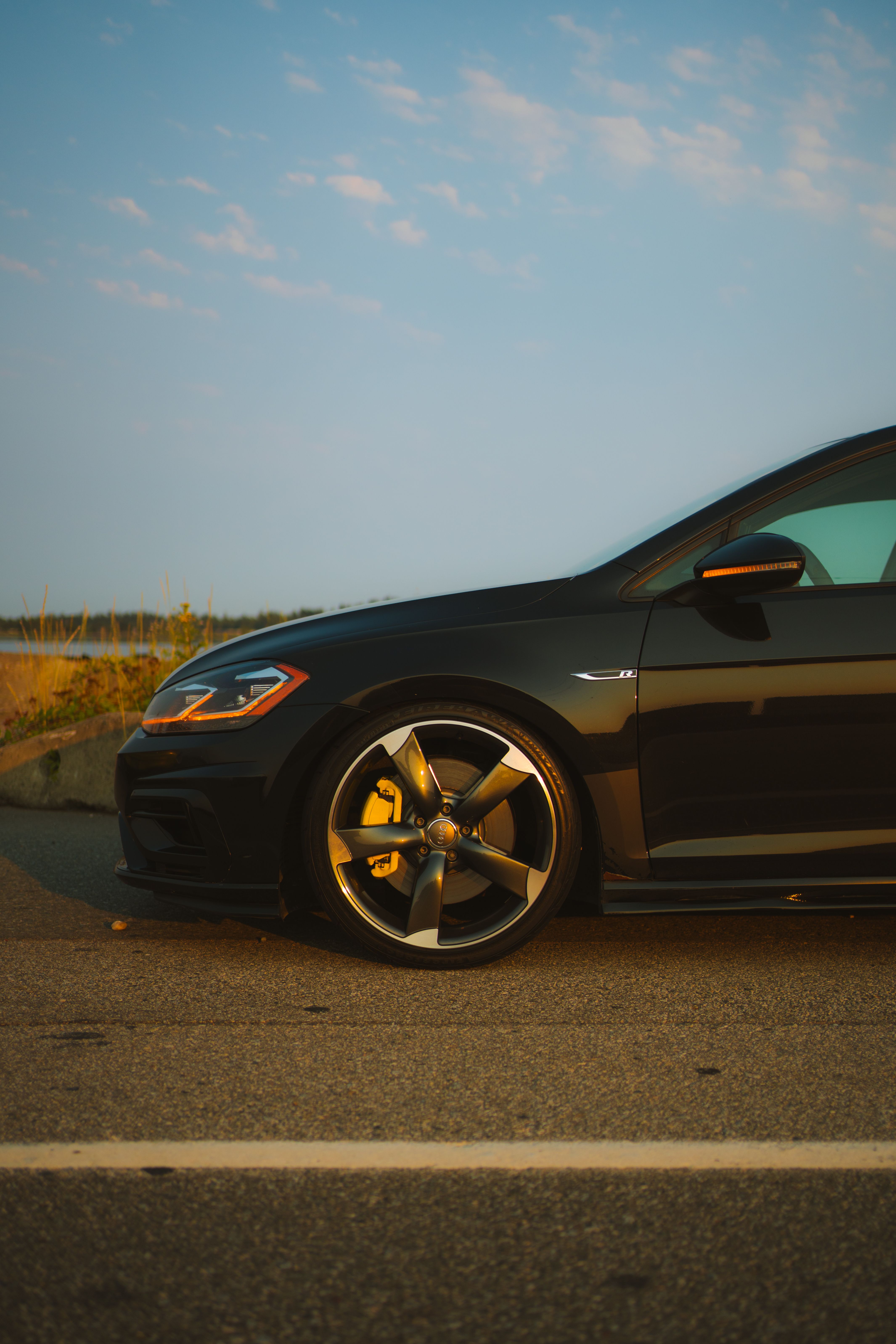 A black car with black rims parked on the side of the road · Free Stock ...