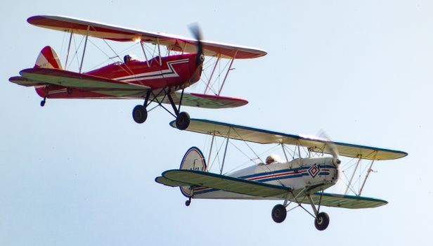 Two small airplanes flying in the sky