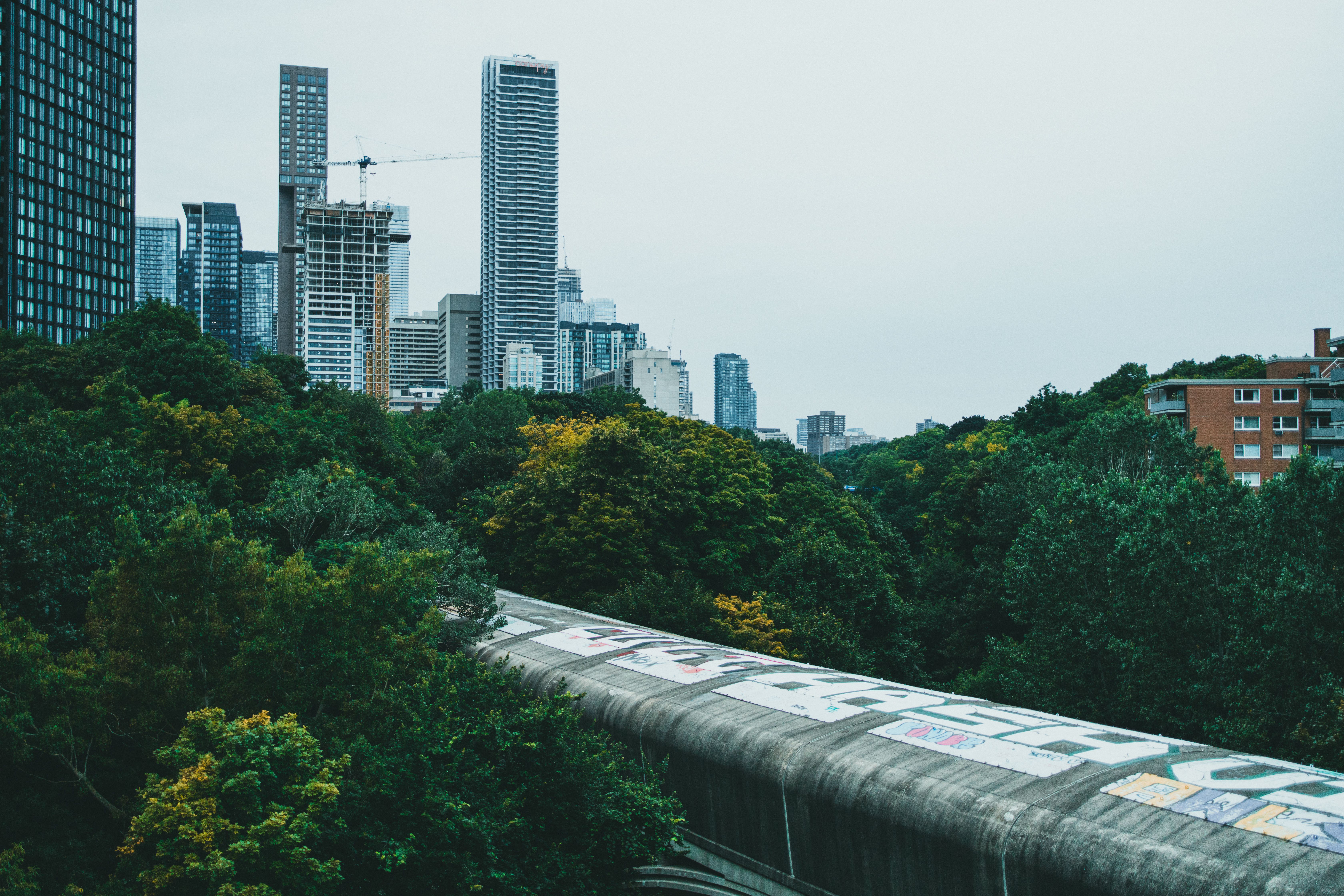 A train tracks with a city skyline in the background · Free Stock Photo