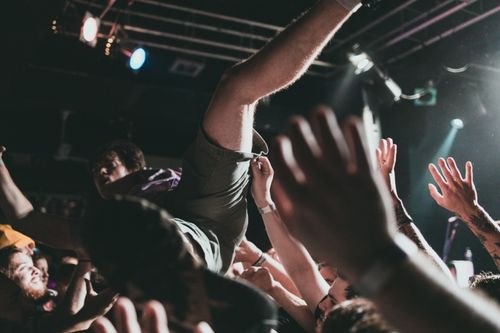 Free Vibrant scene of a crowd surfer at a live music concert, capturing the thrilling atmosphere. Stock Photo
