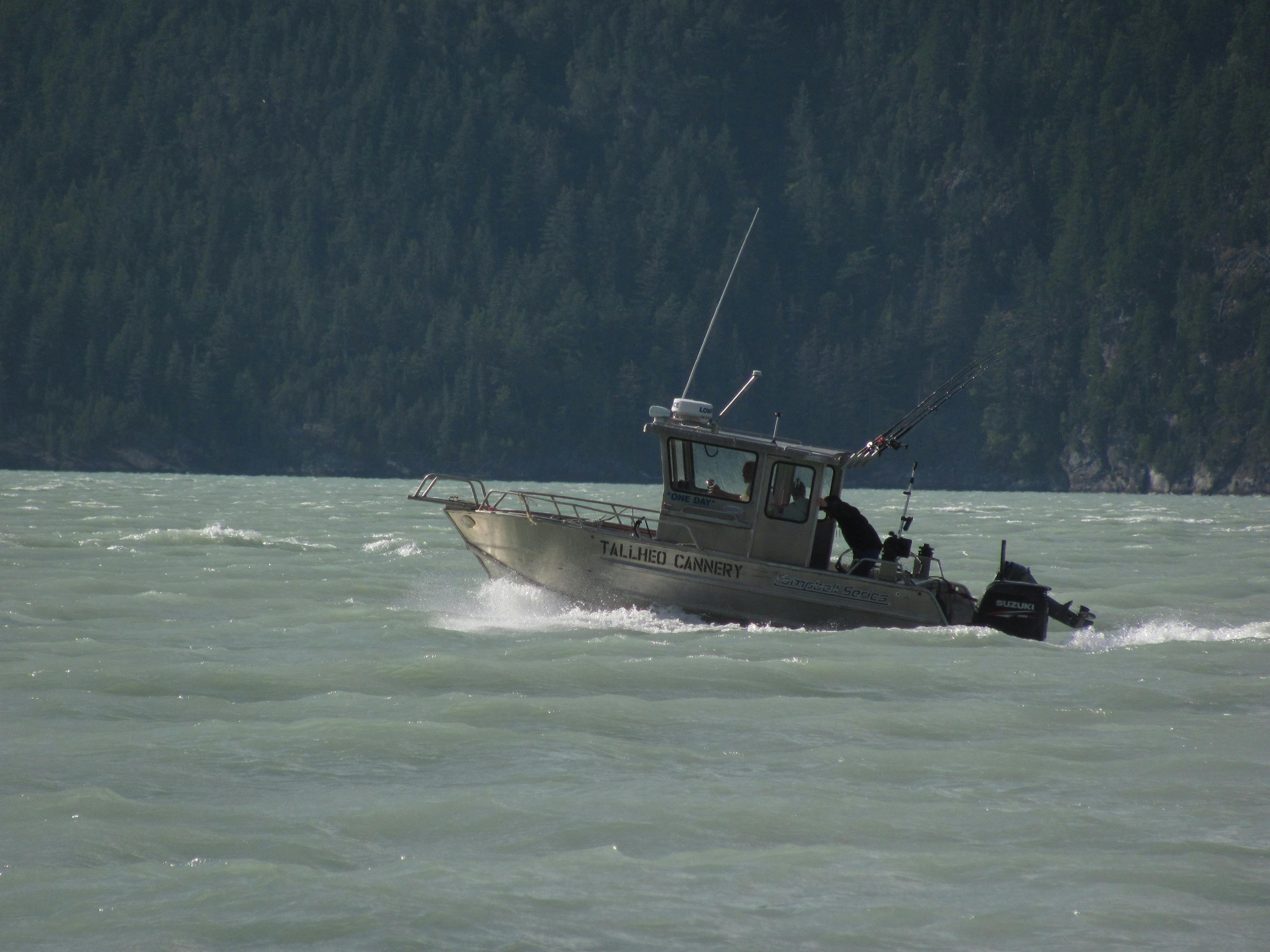 Aluminium fishing boat travelling across choppy water