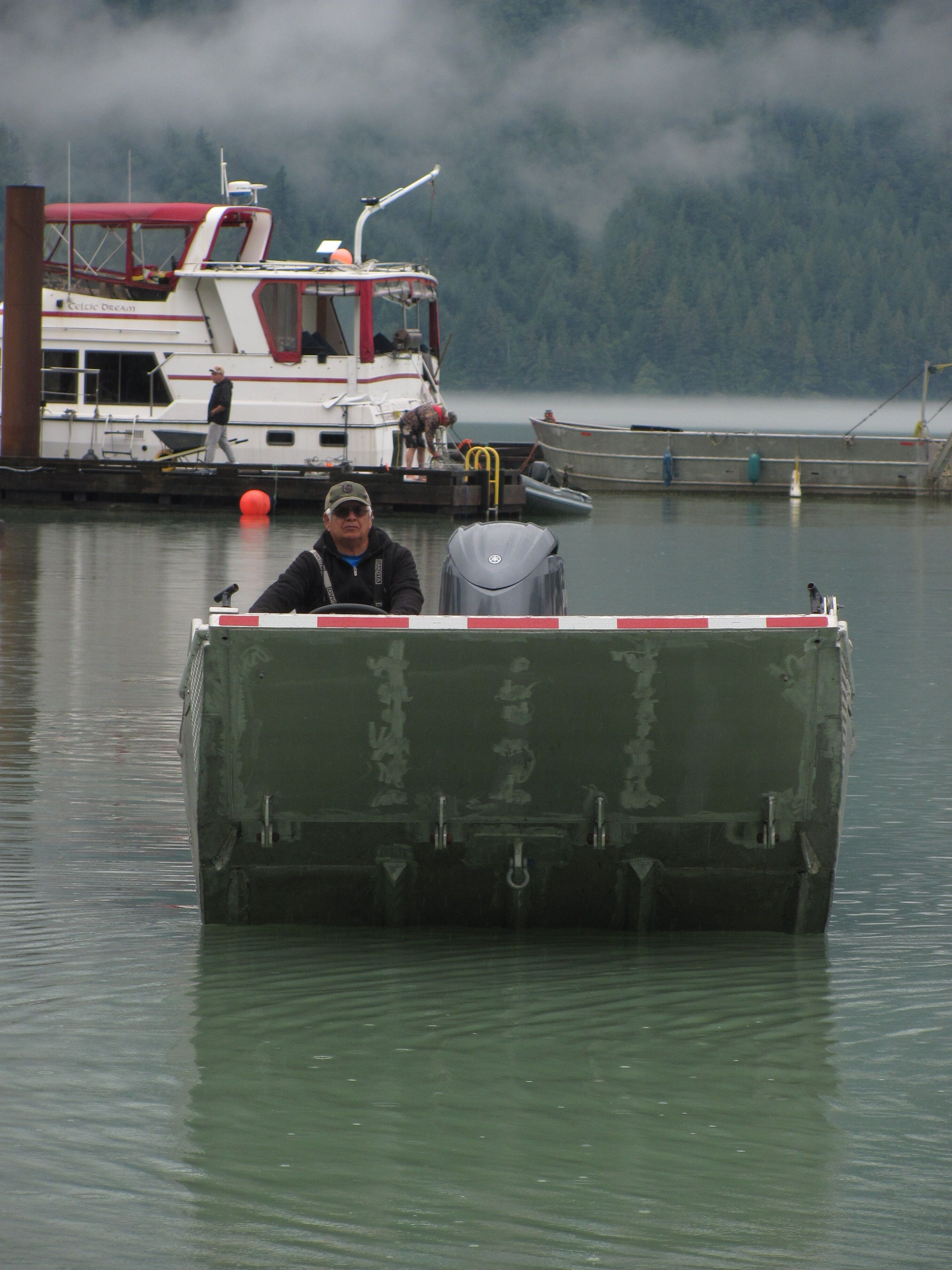 A small motorboat moving through harbour water, a reminder that getting on the water matters more than overbuilding the boat in the shed.