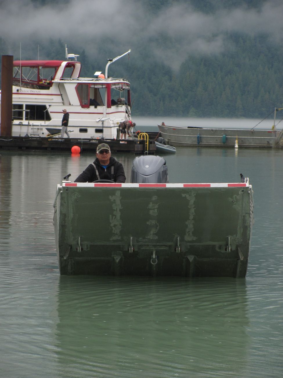 A small motorboat moving through harbour water, a reminder that getting on the water matters more than overbuilding the boat in the shed.