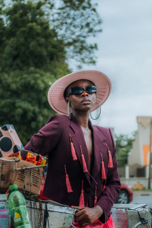 Free Fashion-forward African woman posing with bold accessories outdoors in Nigeria. Stock Photo