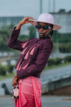 Elegant portrait of an African woman in vibrant fashion, outdoors in Nigeria.