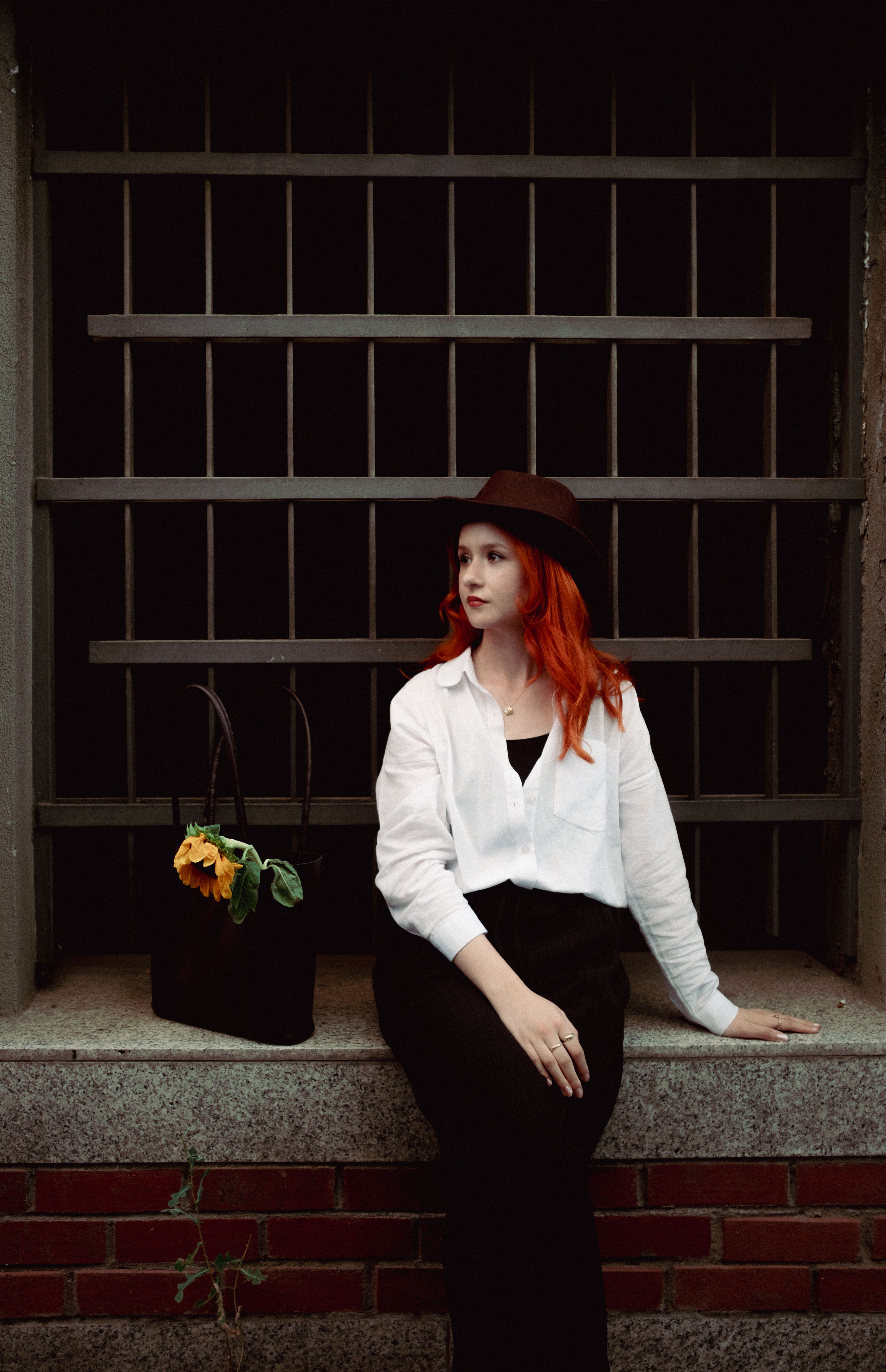 A woman with red hair sitting on a bench · Free Stock Photo